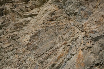 Light brown orange rusty beige gray white stone rock granite background. Mountain surface texture. Close-up. Nature. For design.
