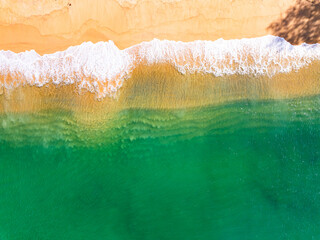 Summer seascape beautiful waves,Tropical sea water in sunny day, Top view from drone camera,Amazing ocean colorful nature background, Beautiful bright sea waves splashing on beach sand