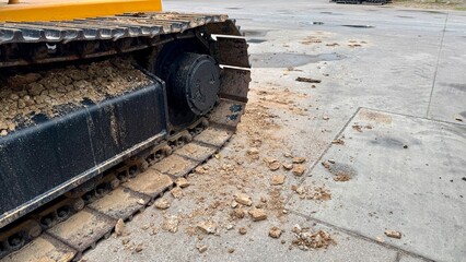 Mechanical Might The robust track of a construction machine stands prominently, detailed with...