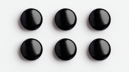 Six glossy black buttons arranged in two rows, creating a simple yet striking visual pattern on a light background.