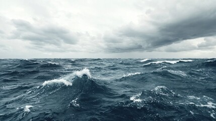 A dramatic view of turbulent ocean waves under a moody, overcast sky, capturing the raw power and beauty of nature.
