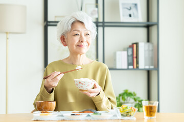朝食を食べるシニアの女性