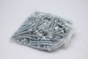 pack of silver metal screws in transparent plastic packaging. Perfect for hardware, construction,...