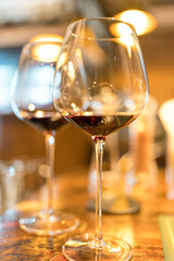 Glasses of red wine on dining table. Two red wineglasses