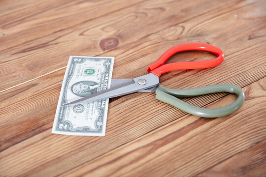 A scissors cut dollar bills