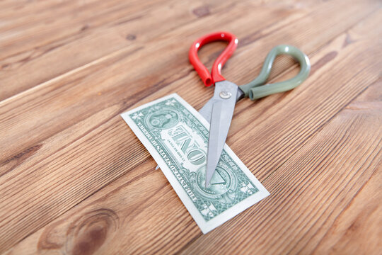A scissors cut dollar bills