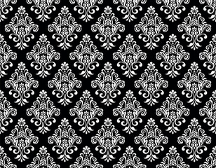 Floral pattern. Seamless vector background. Vintage wallpaper in the Baroque style. White and black ornament for fabric, wallpaper, packaging. Ornate Damask flower illustration.