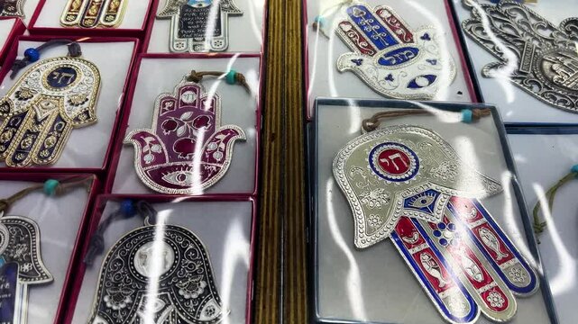 Nazar in market. Blue and red Fatima eye close-up protective amulet against evil eye. Israeli Hamsa David