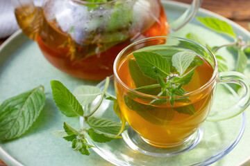 Green tea with mint in a transparent bowl. Healthy food, antioxidants.