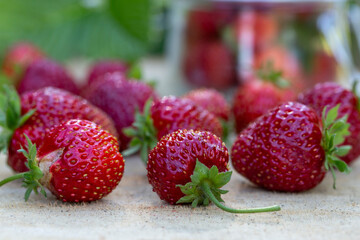 Ripe juicy strawberries on a wooden table. Healthy food rich in fiber, vitamins, antioxidants. Vegetarian food.