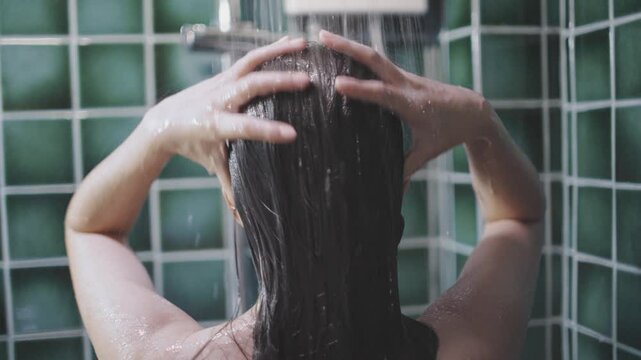 Woman takes a shower and washes her hair night time
