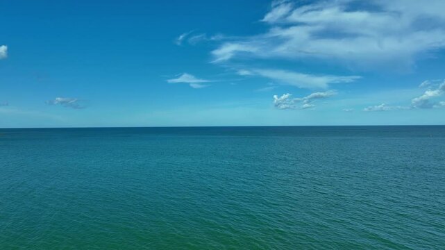 Nature of the beach and sea Summer with sunshine, sandy beaches, clear blue waters sparkling against the blue sky. On an island with good ecology and environment Background for summer vacation	
