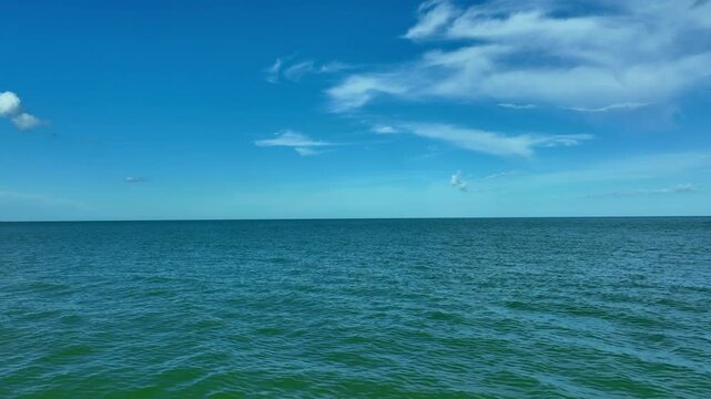 Nature of the beach and sea Summer with sunshine, sandy beaches, clear blue waters sparkling against the blue sky. On an island with good ecology and environment Background for summer vacation	
