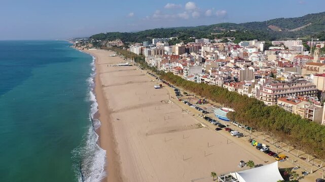 Birds eye view of Calella, Spain. Residential building along Mediterranean sea coast and beach visible from above.