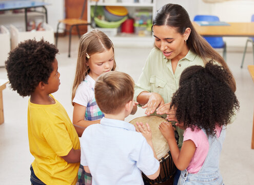 Woman, children and play drums in classroom for creative learning, language development and childhood. Teacher, kids and instruments for teaching music, sensory education and group activity at school