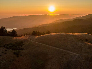 Golden hour sunset over misty hills in Marin County. Scenic vista of Mt Tamalpais mountain path. Nature's beauty at its peak.Marin , California, USA