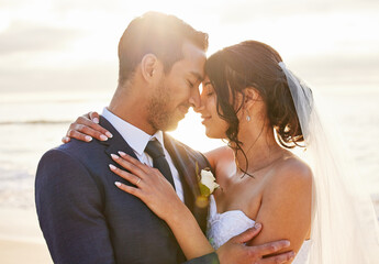 Wedding, forehead touch and couple on beach for celebration, ceremony and marriage in nature....