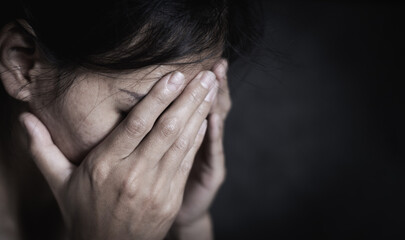 Fototapeta premium Depressed woman. Loneliness Teenage Girls. sad woman cry. Sad woman sitting alone in a empty room. The concept of sexual harassment against women and rape.