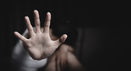 Asian women showing stop gesture with hand blurred background, young female protesting against domestic violence and abuse, bullying, saying no to gender discrimination.