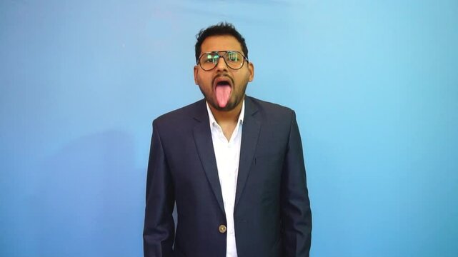An adult man in suits showing his tongue to the camera.