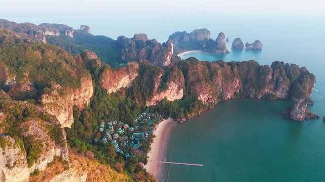 scenic aerial cliff sunset above sea in Krabi Thailand , drone of Railay beach  Andaman sea  in  Ao nang beach drone footage luxury resort vacation holiday travel destination in Asia 