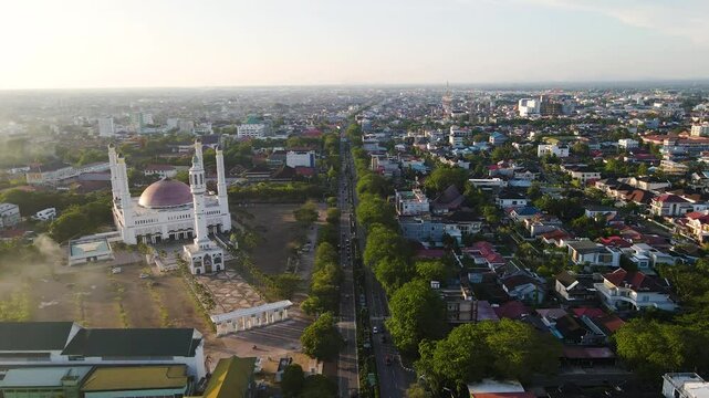 The beauty of the Great Mosque of Mujahidin at dusk seen from a height with a view of the surrounding Pontianak city. This mosque is the largest mosque in Pontianak City, West Kalimantan, Indonesia.