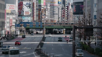 SHINJUKU,TOKYO,JAPAN : 17 Feb 2025 :crowd of people at zebra and train at near Kabukicho downtown area. Buildings, train and street traffic. Japanese urban city