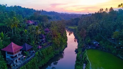 Serene aerial view of lush tropical landscape with river, rice fields, and sunset glow