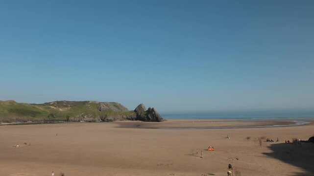 Three Cliffs Bay Time Lapse of Beach-goers on Hot Sunny Day, Gower Peninsula, Swansea, Wales, UK
