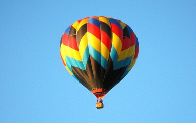 Fototapeta premium Professional stock photo of a Colorful Hot Air Balloon Floating in a Clear Blue Sky