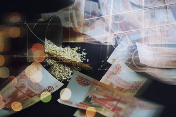 The concept of the cost of grain. 5000 ruble banknotes around a handful of ground grain. World...