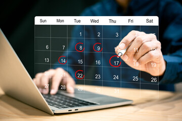 Businessman manages time for effective work. Calendar on the virtual screen interface, Businessman making red circles on important days on the calendar Important appointment dates