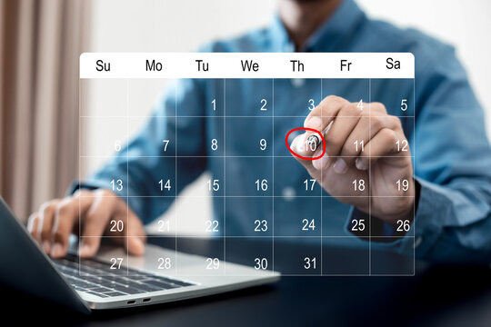 Businessman manages time for effective work. Calendar on the virtual screen interface, Businessman making red circles on important days on the calendar Important appointment dates