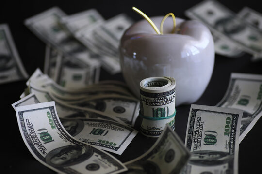Apple on table with money, dollars banknotes. Us business concept. New york big apple. - Powered by Adobe