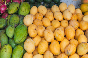 fresh tropical ripe mangoes at an Asian street market in Thailand