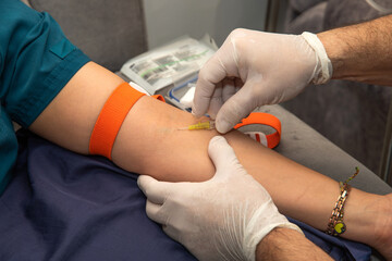 Intravenous in a patient. Close-up, medical procedure, healthcare professional, wearing sterile...