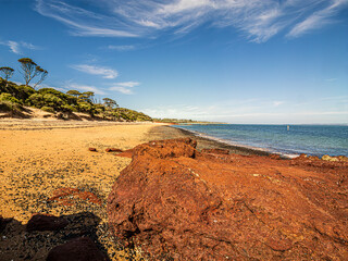 Red Rocks Lead To Messy Beach