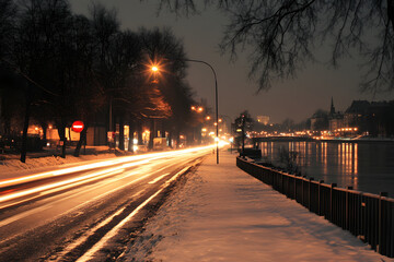 Night City Lights Illuminate Snowy Street, River Reflections Gleam