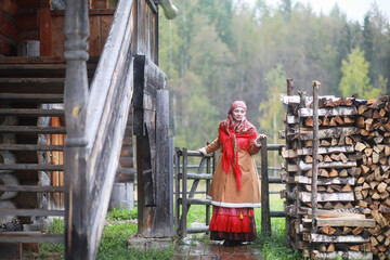 Traditional Slavic rituals in the rustic style. Outdoor in summer. Slavic village farm. Peasants in elegant robes.