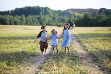 Children walk in the summer in nature. Child on a sunny spring morning in the park. Traveling with children.