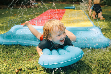 Summer backyard slip and slide family fun