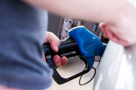 Service station fuel pump detail of nozzles for unleaded 91 petrol filling up car