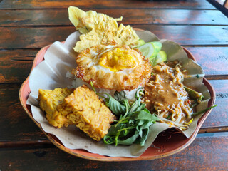 Nasi pecel or sego pecel is a typical Javanese Indonesian rice dish served with pecel sauce,...