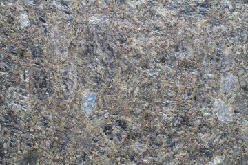 Natural unpolished Labradorite granite. Stone rock texture close-up.