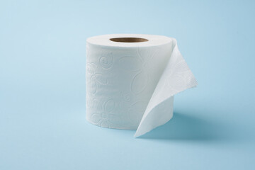 Top view of toilet paper roll on blue background