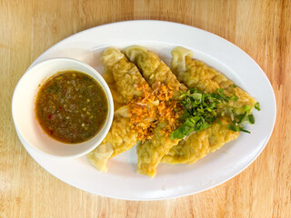 Dumplings, shrimp dumplings, pork dumplings, chicken dumplings, fried dumplings, boiled dumplings, dumplings and dipping sauces, seafood dipping sauces, food, Thai food, delicious food, photos, real p