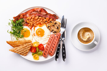 A classic breakfast plate featuring sunny-side-up eggs, crispy bacon, sausages, and fresh tomatoes