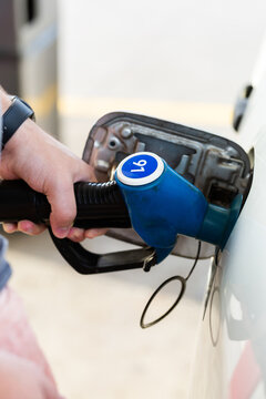 Service station fuel pump detail of nozzles for unleaded 91 petrol filling up car