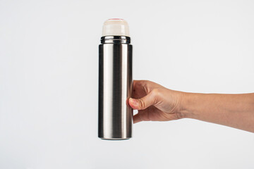 Bottle tumbler aluminium water glass and hand isolated white background.
