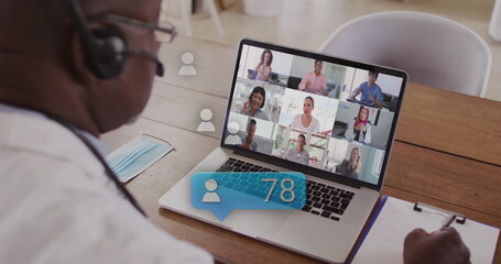 Image of data processing over african american businessman using laptop on image call